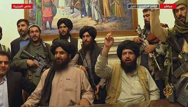 An image grab taken from Al-Jazeera on August 16, 2021, shows members of Taliban taking control of the presidential palace in Kabul.