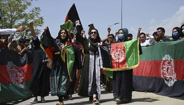 Afghans celebrate the 102th Independence Day of Afghanistan with the national flag in Kabul on August 19, 2021.