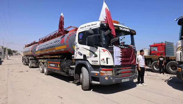 Picture shows a tank truck raising Qatari flags transporting fuel for Gaza's sole power plant arriving at the Rafah crossing in the southern Gaza Strip.