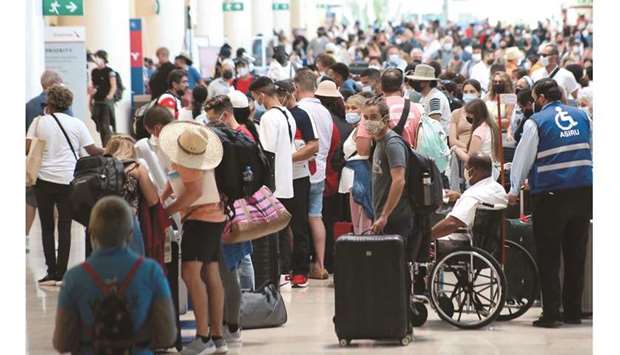 Tourists wait to depart from Cancunu2019s international airport before the arrival of Hurricane Grace, in Cancun, Mexico.