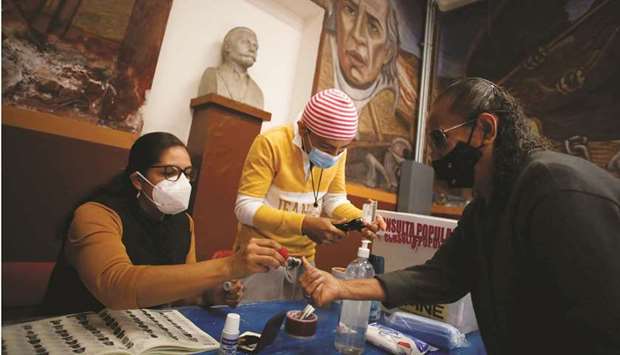 People take part in a referendum at a polling station in Mexico City yesterday. (Reuters)