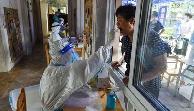 A resident receives a nucleic acid test for the Covid-19 coronavirus in Nanjing in China's eastern Jiangsu province, amid the country's most widespread coronavirus outbreak in months.