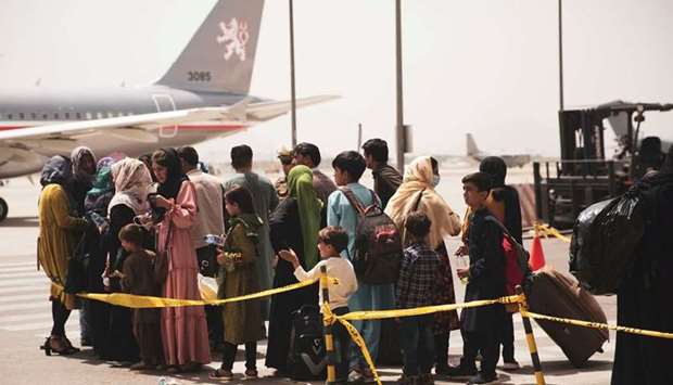 Civilians prepare to  board a plane during an evacuation at Hamid Karzai International Airport, Kabul, Afghanistan, recently. (Reuters)