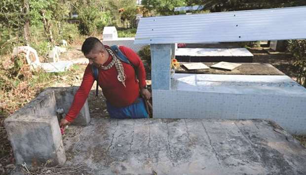 Colombian peasant Efrain Soto, who was victim of a landmine, visits the tomb of his brother, who died after stepping on an explosive device in Catatumbo, early this month. (AFP)
