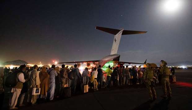 This handout photo taken on August 20 from the Australian Defence Force shows people forming a line to board the Royal Australian Air Force C-17A Globemaster in Kabul. SGT Glen McCarthy / Australian Defence Force / AFP