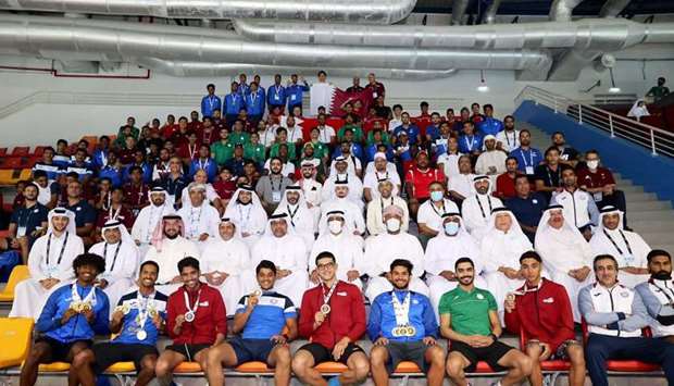 Officials and medal winners pose for a group photo.