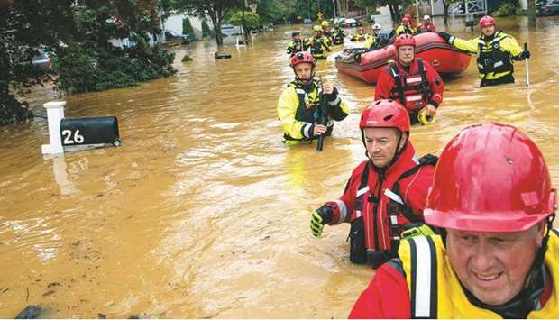 Members of the New Market Volunteer Fire Company perform a  secondary search during an evacuation effort following a flash flood as Tropical Storm Henri made landfall in Helmetta. (AFP)