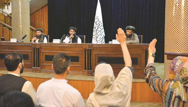 Taliban spokesperson Zabihullah Mujahid (centre) gestures towards journalists raising their hands to ask a question during a press conference in Kabul yesterday. (AFP)