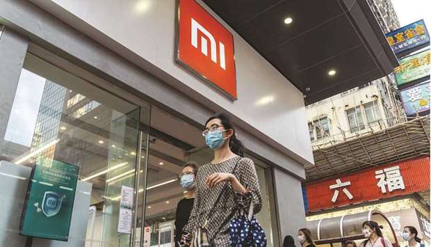 Pedestrians walk past a Xiaomi Corp store in Hong Kong. Xiaomi will buy autonomous driving technology startup Deepmotion for about $77.4mn, sealing a deal to help further its ambitions of getting into the fast-expanding field.