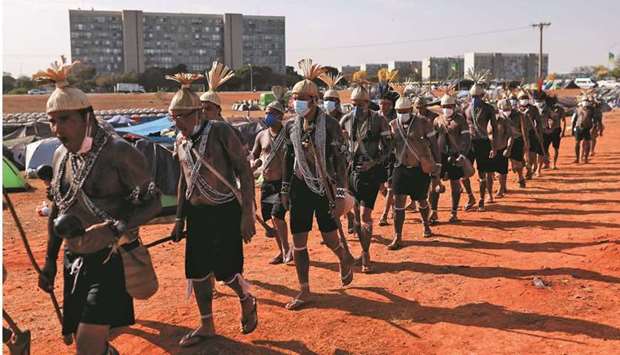 Indigenous people sing and march at camp Luta pela Vida (Struggle for Life) before a  protest for indigenous land rights in Brasilia.