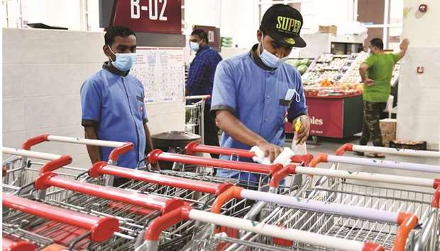 Shopping carts are continuously sanitised at Al Sailiya Central Market. PICTURES: Ram Chand.
