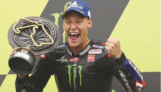 Yamaha French rider Fabio Quartararo celebrates on the podium after winning the British Grand Prix at Silverstone Circuit in Northamptonshire, central England, yesterday. (AFP)