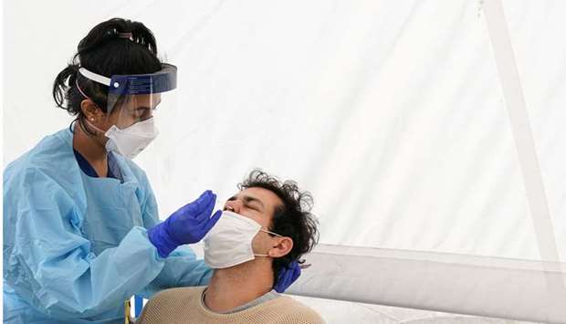 A medical worker administers a test for Covid-19 on a member of the public at a pop-up testing centre in Sydney, Australia, yesterday.