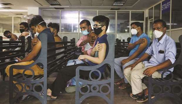 People wait at the observation area after receiving a dose of Covishield, a vaccine against Covid-19 manufactured by Serum Institute of India, at a hospital in Noida on the outskirts of New Delhi, India, yesterday.
