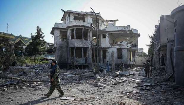 An Afghan security personnel inspects the site a day after a car bomb explosion in Kabul on Wednesday. Photo: AFP