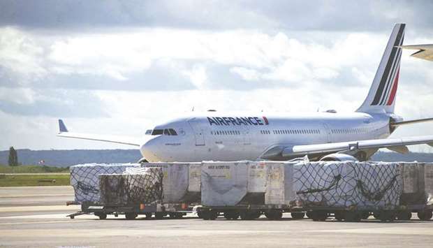 Cargo on trolleys beside an Airbus SE A330 passenger aircraft, operated by Air France-KLM, at Charles de Gaulle airport in Roissy, France. Amid the pandemic-induced challenges, it has been a very good first half for global air cargo, which registered a growth of 8%, its strongest half-yearly performance since 2017.