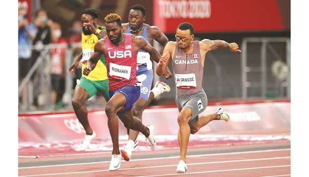 Andre De Grasse (right) of Canada in action on his way to winning the 200m final ahead of silver medallist Kenneth Bednarek (second left) at the Tokyo 2020 Olympics yesterday. (Reuters)