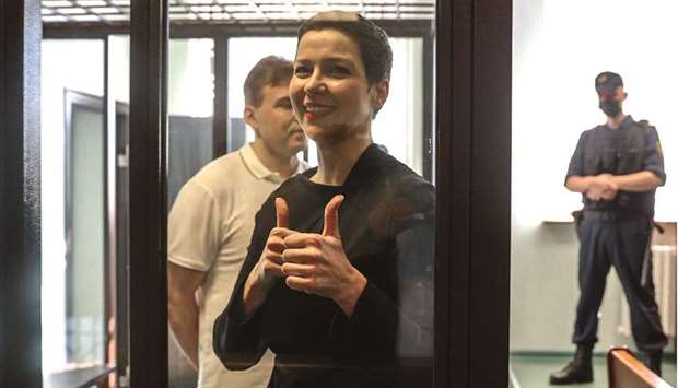 Maria Kolesnikova gestures inside the defendantsu2019 cage at the opening of her trial in Minsk yesterday. (AFP)