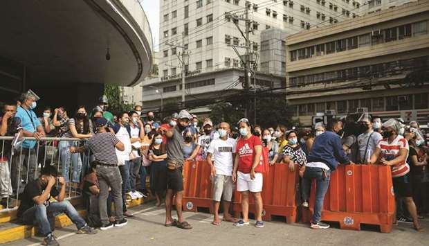 Filipinos waiting to be vaccinated against Covid-19 gather outside a mall in Manila yesterday.
