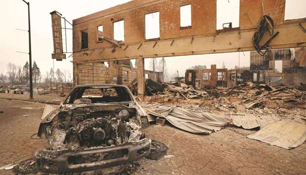 A burned-out car and commercial building are seen in the town of Greenville.