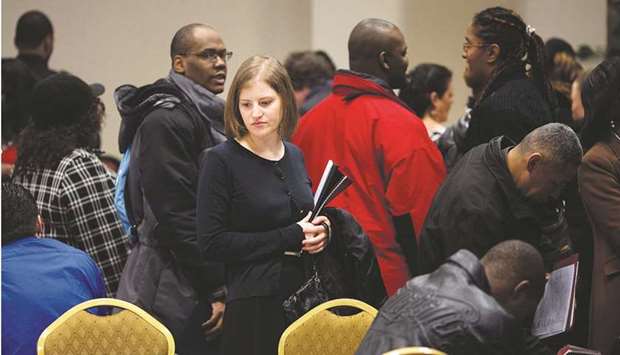 Job seekers talk to recruiters and fill out applications at a job fair in New York (file). US job growth powered ahead and the unemployment rate fell in July amid demand for workers in the labour-intensive services sector, quashing fears of a hiring slowdown and suggesting the economy began the second half of the year with strong momentum.
