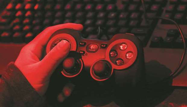 A gamer uses a Logitech Logicool gamepad F310r to play video games at an esports hotel in Japan. Singapore may not compete for gold in many Olympic events, but the tiny city-state is emerging as a force in a different kind of sport: Mobile and video games.