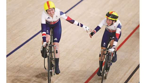 Britainu2019s Laura Kenny (right) and Katie Archibald celebrate after winning the womenu2019s track cycling madison final at the Tokyo Olympic Games in Izu, Japan. (AFP)