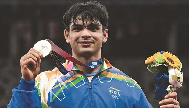 Indiau2019s Neeraj Chopra poses with the gold medal after winning the javelin throw event at Tokyo Olympics. (AFP)
