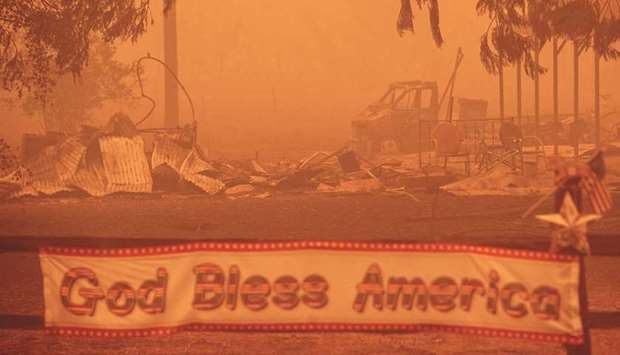 A patriotic banner is seen in front of a burnt-out property during the Dixie fire in Greenville, California.