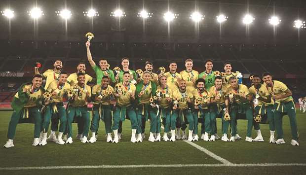 Brazil players pose for pictures during the medal ceremony in Yokohama. (AFP)