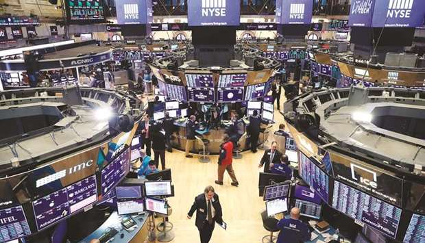 Traders work on the floor of the New York Stock Exchange (file). The economic boost from an expected $1tn infrastructure bill working its way through the US Senate has helped push Wall Street stocks near record levels, but some investors are concerned that the next two months in Washington could be rocky.