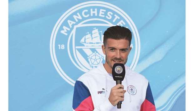 Jack Grealish speaks to Manchester City fans outside the Etihad Stadium during his unveiling in Manchester yesterday. (AFP)