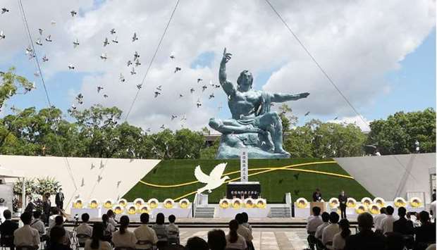 Doves fly during a memorial service for victims of the US atomic bombing at the Nagasaki Peace Park in Nagasaki as the city marks the 76th anniversary of the bombing.