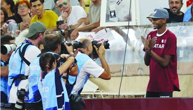 Qatar's Mutaz Essa Barshim poses for pictures after winning the High Jump Men event at the Wanda Diamond League athletics meeting at the Louis II Stadium in Monaco. AFP