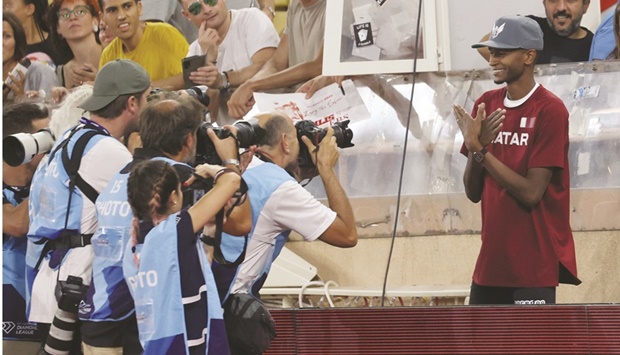 Qataru2019s Mutaz Barshim poses for pictures after winning the high jump event during the Monaco Diamond League meeting at the Louis II Stadium in Monaco yesterday. (AFP)
