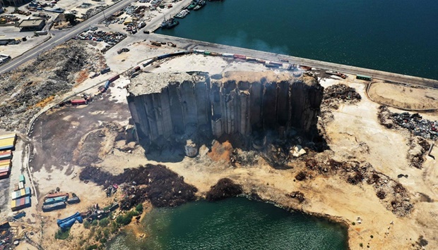 This aerial view shows smoke rising from the heavily damaged grain silos in Beirutu2019s blast-hit port.