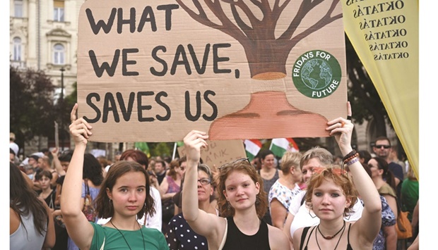 Young girls hold up a placard during a protest against the newly passed deforestation law, in front of the parliament building in Budapest.