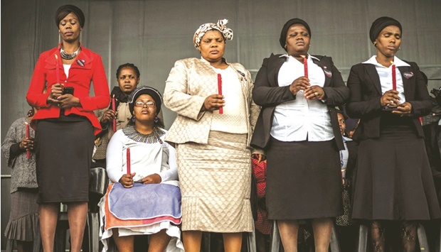 In a file picture, widows and bereaved family members attend a ceremony in Marikana paying tribute to miners who where gunned down by the South African police during a violent wave of strikes two years ago.