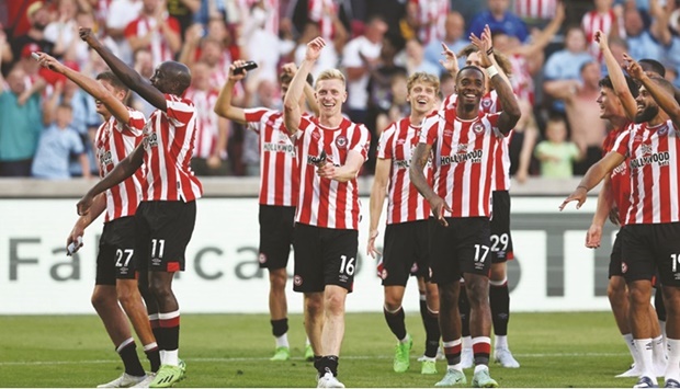 Brentford players celebrate after their win over Manchester United in the Premier League in London yesterday. (Reuters)