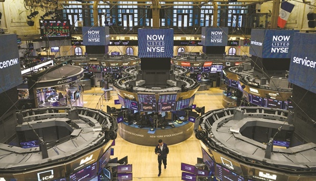 Traders work on the floor of the New York Stock Exchange (file). Optimism is seeping back into the US stock market, as some investors grow more convinced that the economy may avoid a severe downturn even as it copes with high inflation.