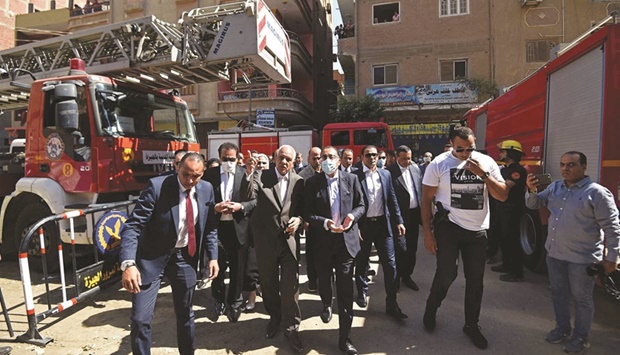Egyptu2019s Prime Minister Mostafa Madbouli (centre) visits the Abu Sifin Coptic church after a fire broke out yesterday killing 41 people.