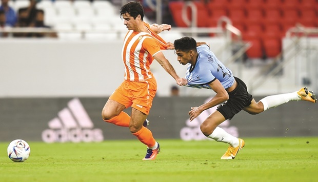 Umm Salalu2019s Joao Carlos Teixeira (left) and Al Wakrahu2019s Nabil Irfan tussle for the ball during the QNB Stars League at the Al Thumama Stadium on Monday. PICTURE: Noushad Thekkayil