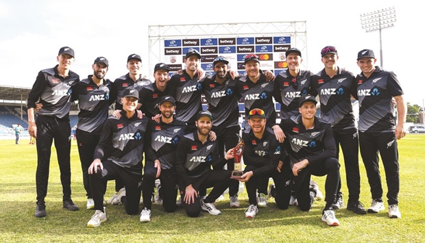 New Zealand players pose with the trophy after winning the series at Sabina Park, Kingston, Jamaica.(AFP)