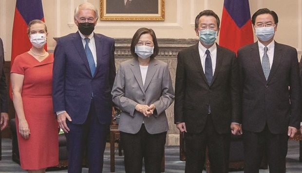Taiwan President Tsai Ing-wen (centre) poses for photographs with US delegation at the Presidential Office in Taipei yesterday.