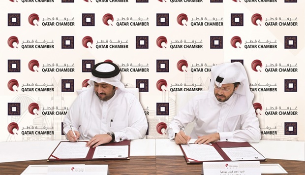 Qatar Chamber Public Relations Department acting director Ahmed Abu Nahya and Qatari Diar director of CEO Office and Public Relations Department Ahmed Mohamed al-Sada signing the agreement.