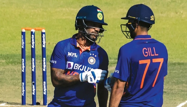 Indiau2019s Shikhar Dhawan (left) and Shubman Gill bump fists between overs during the first one-day international against Zimbabwe at the Harare Sports Club in Harare yesterday. (AFP)