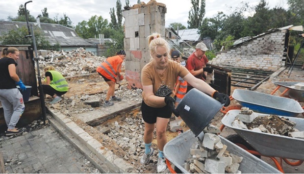 Volunteers clear the rubble of a house destroyed as a result of the shelling in the city of Chernihiv, Ukraine.