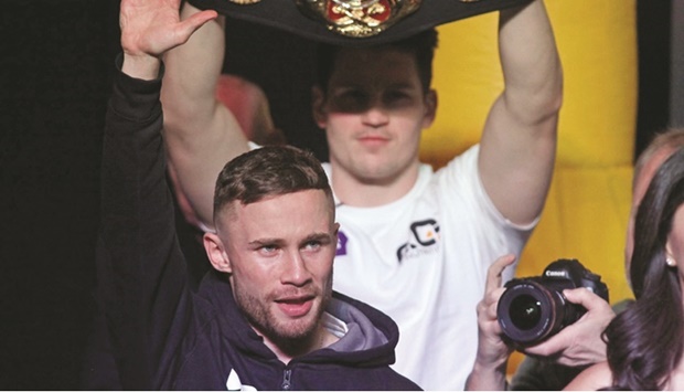 This 2017 photo shows Northern Irelandu2019s Carl Frampton acknowledging fans before his weigh-in, with Leo Santa Cruz of the US in the background, at the MGM Grand Arena in Las Vegas.
