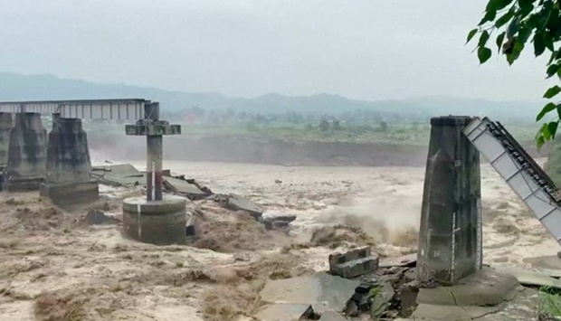 A general view of a bridge that collapsed following heavy rains in Kangra, Himachal Pradesh, India August 20, 2022 in this screen grab obtained from a video.