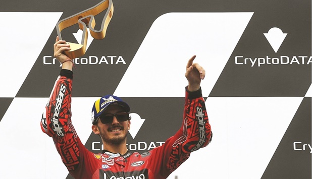 Ducati Lenovou2019s Italian rider Francesco Bagnaia celebrates on the podium after winning the MotoGP Austrian Grand Prix at the Redbull Ring racetrack in Spielberg yesterday. (AFP)